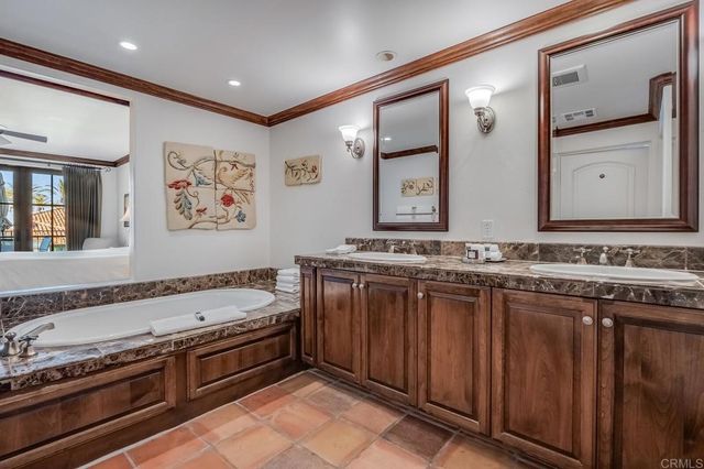 a spacious bathroom with a granite countertop tub sink and mirror