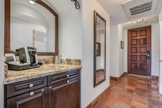a spacious bathroom with a granite countertop sink and a mirror