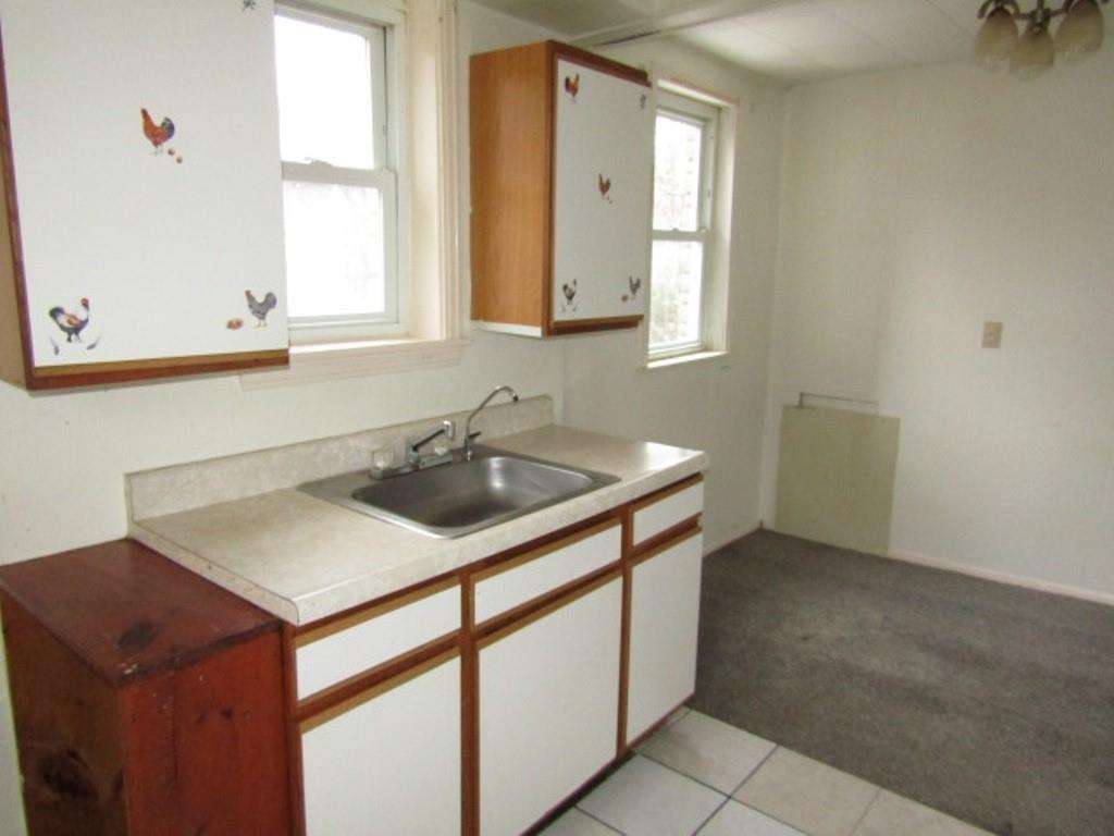 247 Conson Road Pittsburgh, PA 15227 - Photo 11 of 27 a kitchen with a sink cabinets and a window