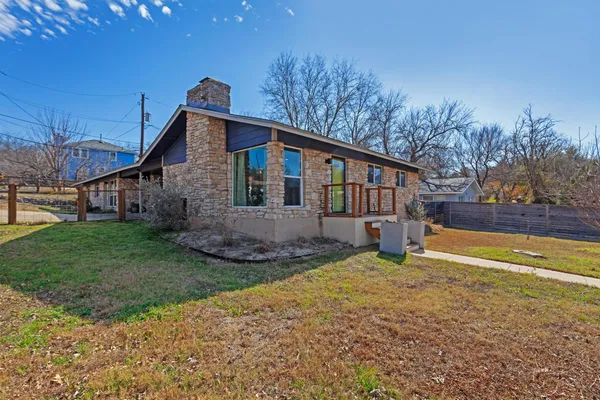 a view of a house with a yard and sitting area