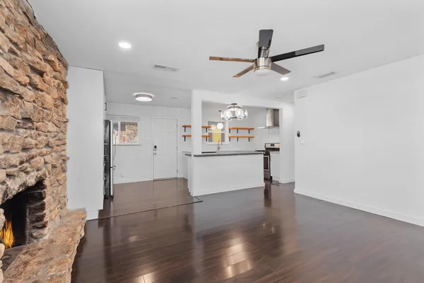 a view of a kitchen with furniture and wooden floor
