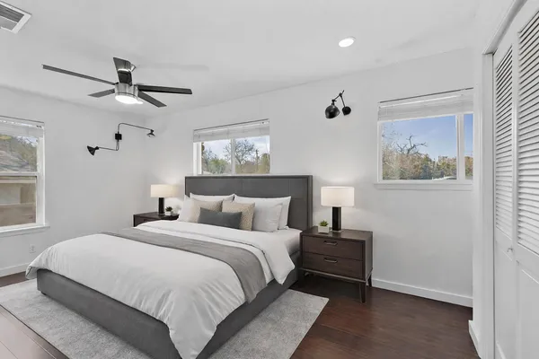 a bedroom with a bed and a painting on the wall