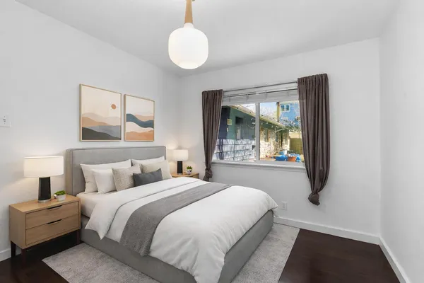 a bedroom with a bed and window