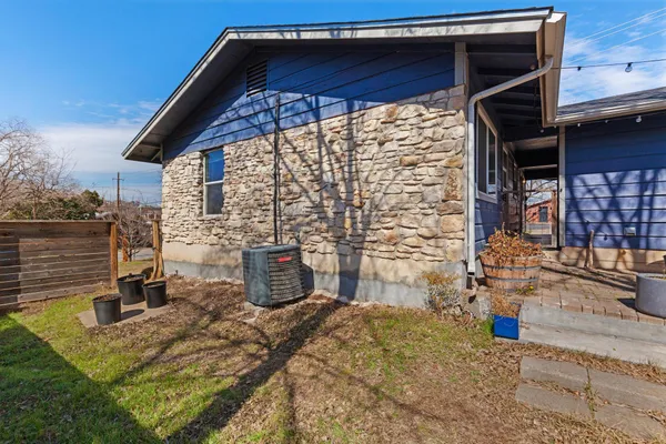 a backyard of a house with barbeque oven table and chairs