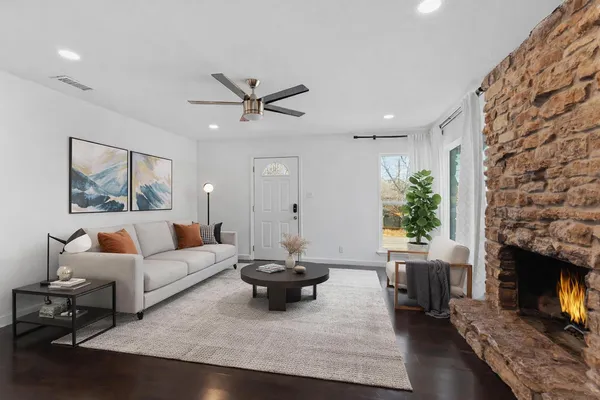 a living room with furniture and a fireplace