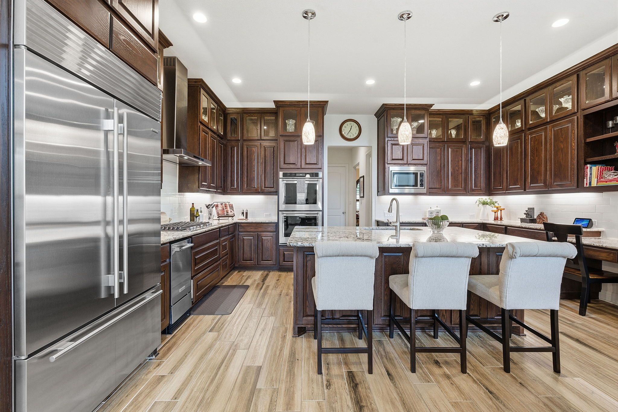 2824 Wedgescale Pass Leander, TX 78641 - Photo 11 of 40 The chef's kitchen boasts an oversized center island, custom refrigerator, double ovens, and a walk-in pantry