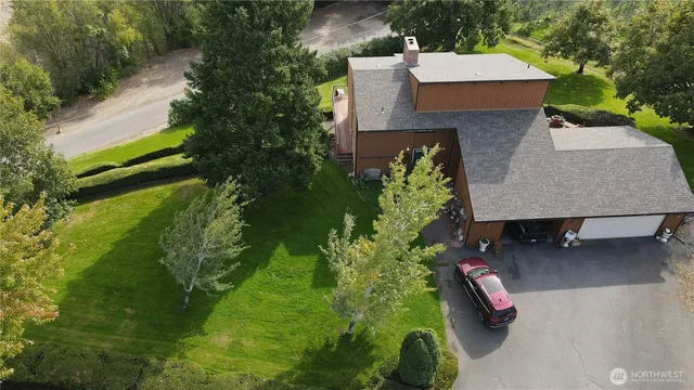 an aerial view of a house with a yard basket ball court and outdoor seating
