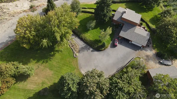 an aerial view of a house with a yard and lake view