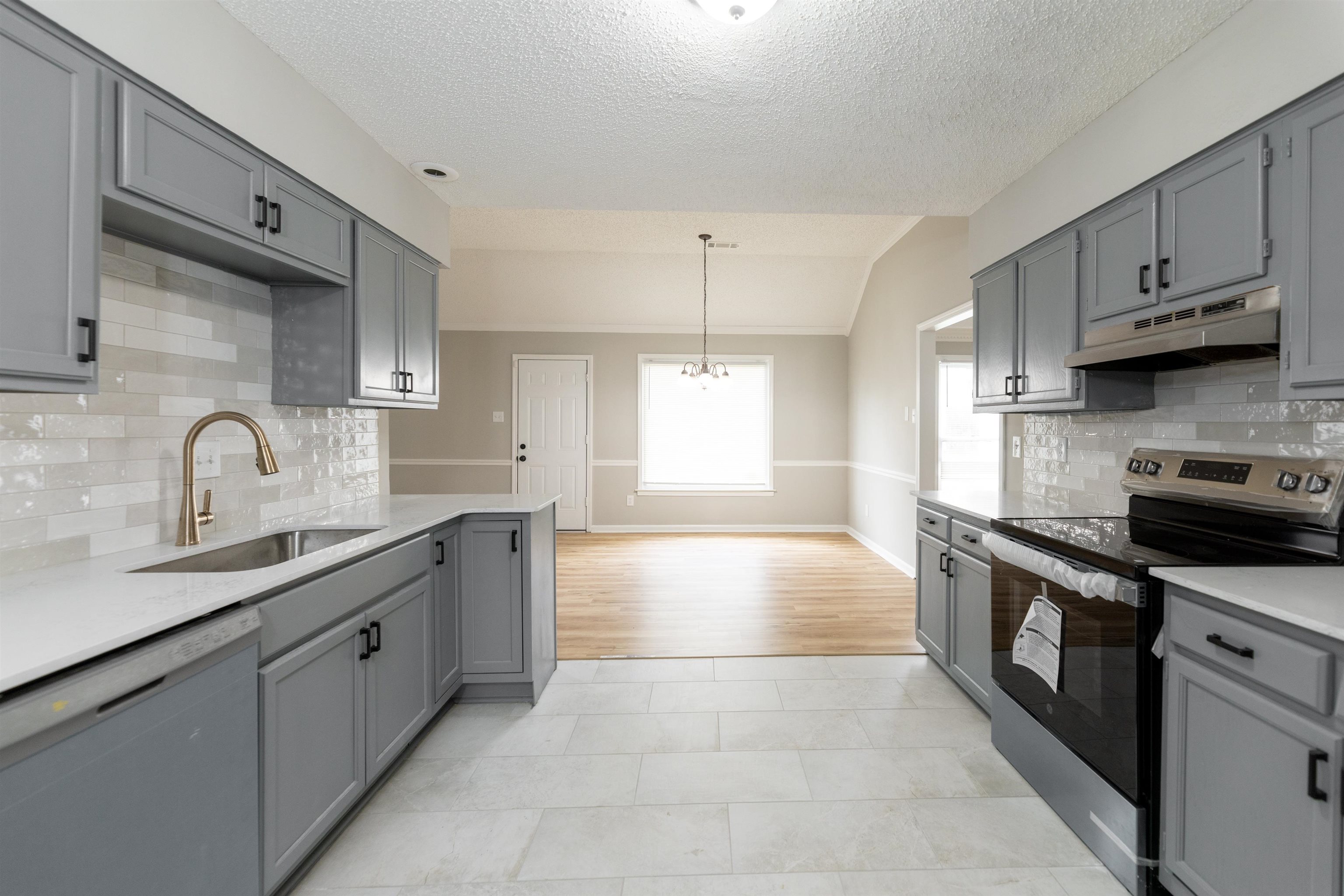 7421 Richmond Road Memphis, TN 38125 - Photo 10 of 39 Contemporary kitchen featuring gray shaker-style cabinetry, white countertops, and a subway tile backsplash