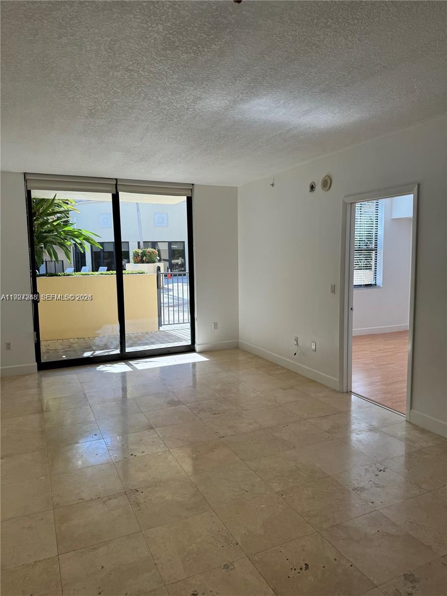 55 Merrick Way, Unit 505 Coral Gables, FL 33134 - Photo 7 of 15 a view of an empty room with a window