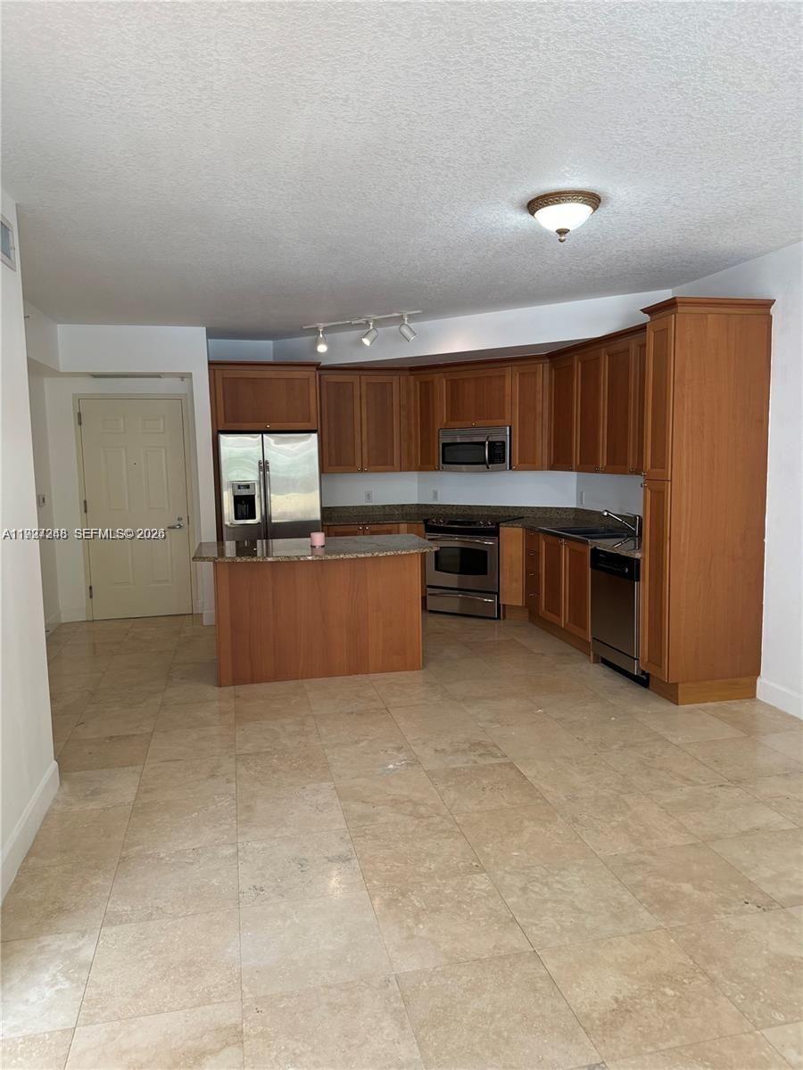 55 Merrick Way, Unit 505 Coral Gables, FL 33134 - Photo 8 of 15 a view of kitchen center microwave and cabinets
