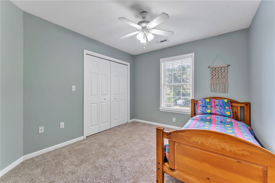 154 Hammond School Road Anderson, SC 29621 - Photo 18 of 33 This cozy bedroom features comfortable flooring and ample natural light, creating a bright and inviting atmosphere.