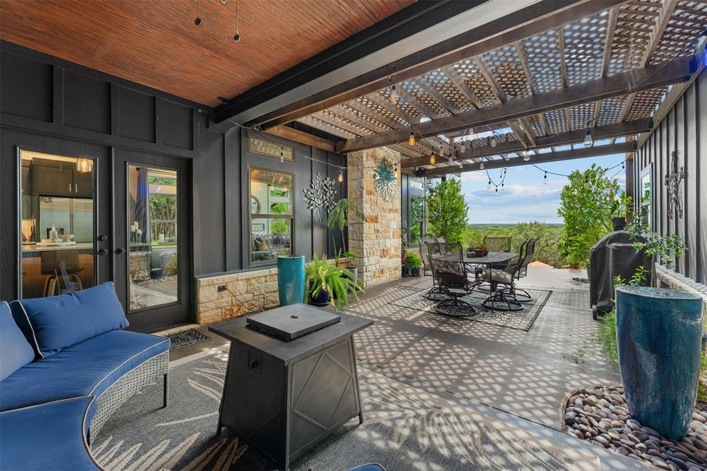 124 Bluffview Circle China Spring, TX 76633 - Photo 30 of 40 Covered outdoor patio featuring a wood-finish ceiling, stone veneer accents, and a slatted pergola