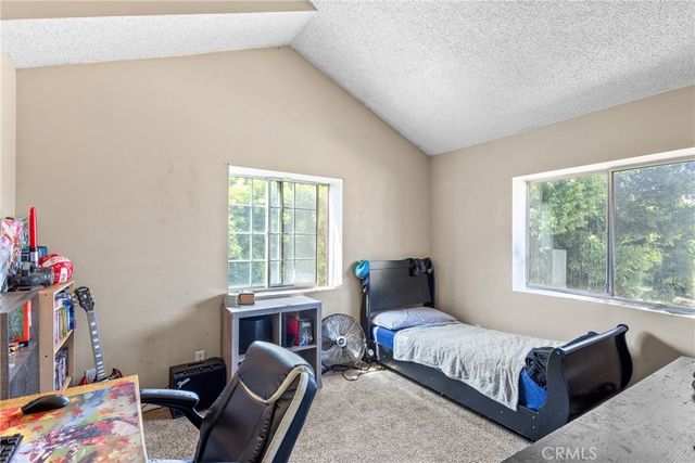 a bedroom with furniture and a window
