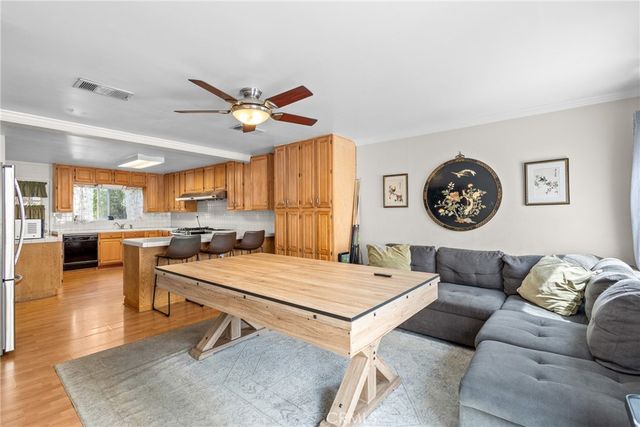 a living room with furniture and a view of kitchen