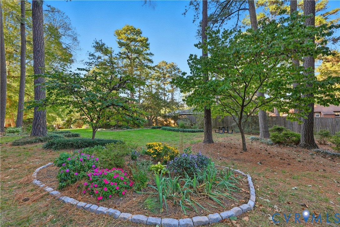 2956 Hathaway Road, Unit 609 Richmond, VA 23225 - Photo 28 of 32 a view of a garden with plants and large trees