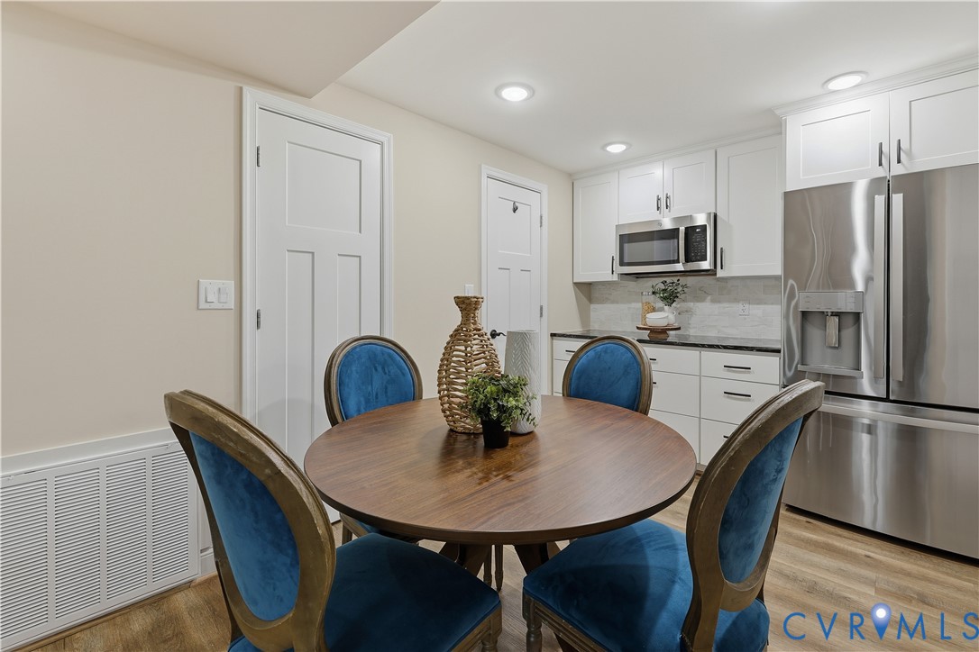 2956 Hathaway Road, Unit 609 Richmond, VA 23225 - Photo 6 of 32 a kitchen with stainless steel appliances granite countertop a dining table chairs and refrigerator