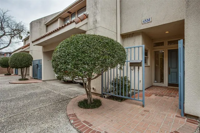 a view of a house with potted plants