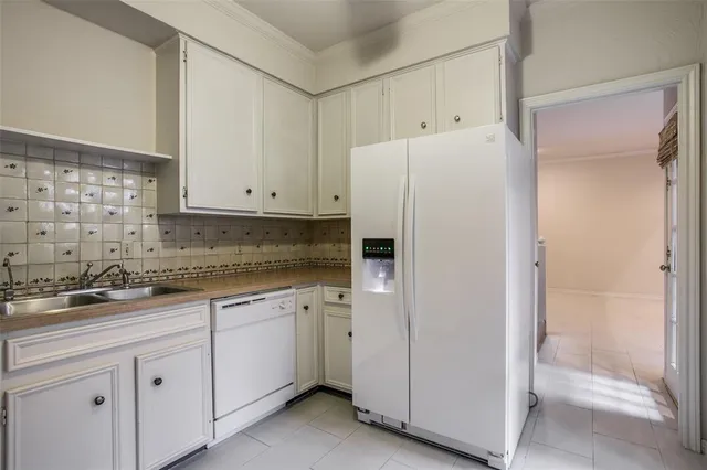 a white refrigerator freezer sitting inside of a kitchen