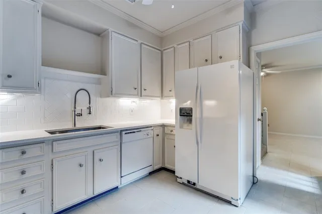 a white refrigerator freezer sitting inside of a kitchen