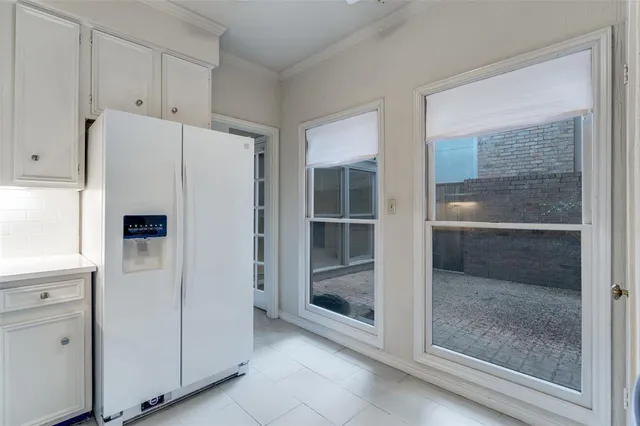 a view of kitchen with a refrigerator cabinets and a sink