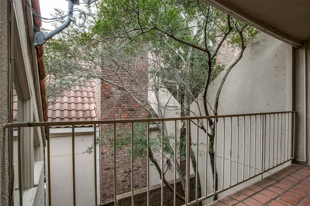 a view of staircase with railing and white walls