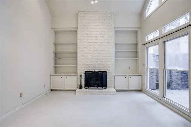 a view of a livingroom with an empty space and a fireplace