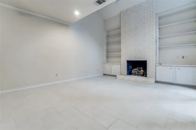 a view of an empty room with a fireplace