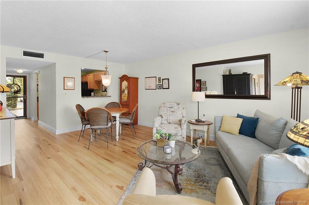 5403 Southeast Miles Grant Road, Unit H111 Stuart, FL 34997 - Photo 11 of 57 a living room with furniture and a flat screen tv