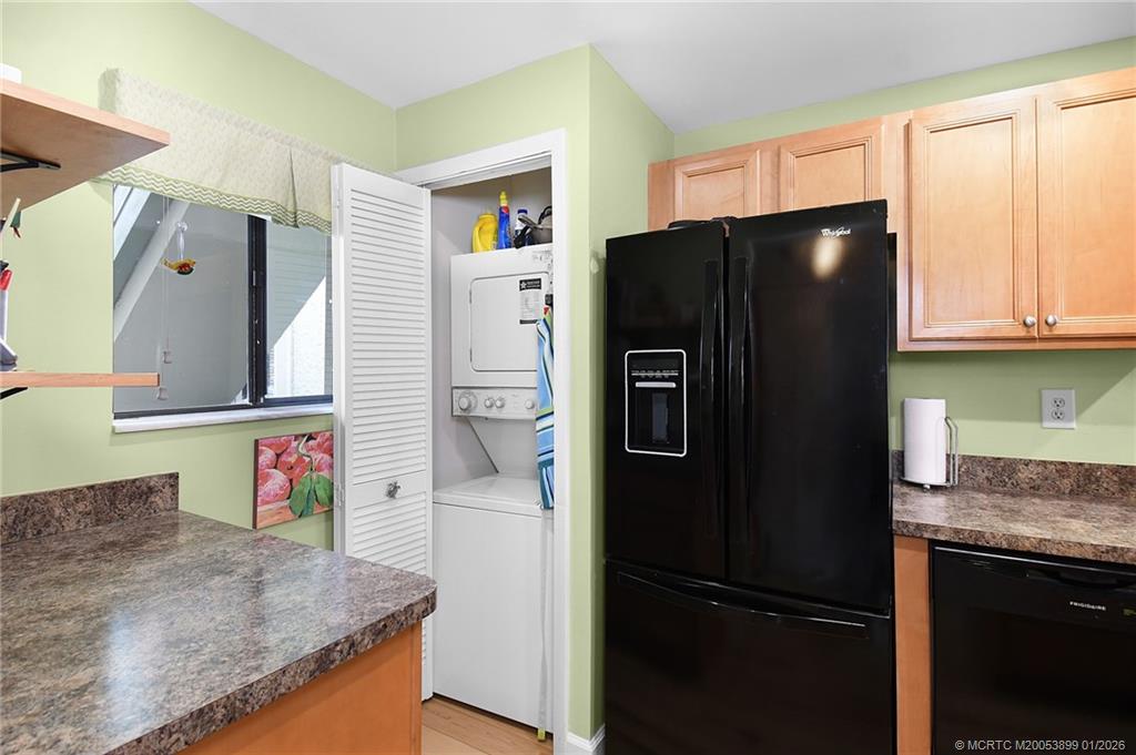 5403 Southeast Miles Grant Road, Unit H111 Stuart, FL 34997 - Photo 16 of 57 a kitchen with stainless steel appliances granite countertop a refrigerator and a sink
