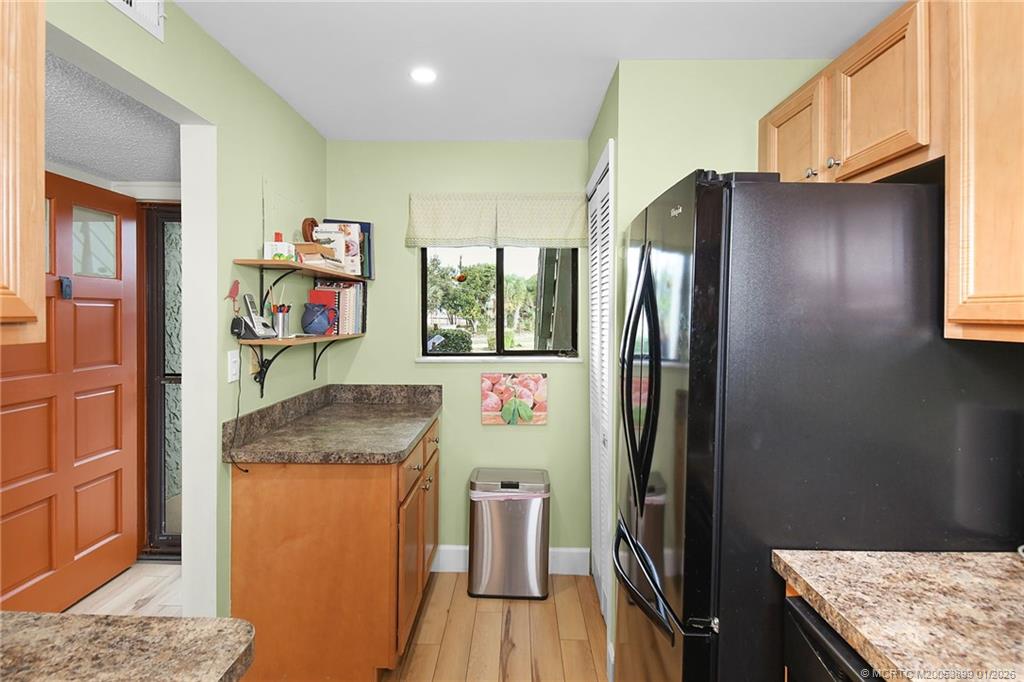 5403 Southeast Miles Grant Road, Unit H111 Stuart, FL 34997 - Photo 17 of 57 a kitchen with stainless steel appliances granite countertop a refrigerator and a sink