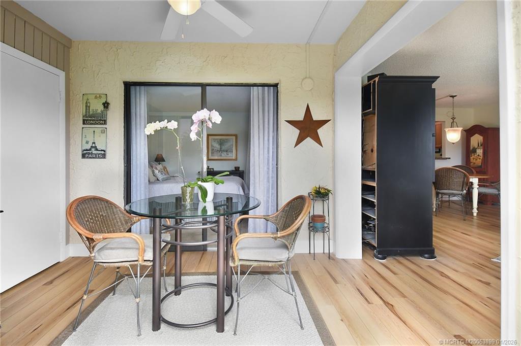 5403 Southeast Miles Grant Road, Unit H111 Stuart, FL 34997 - Photo 18 of 57 a dining room with furniture and wooden floor