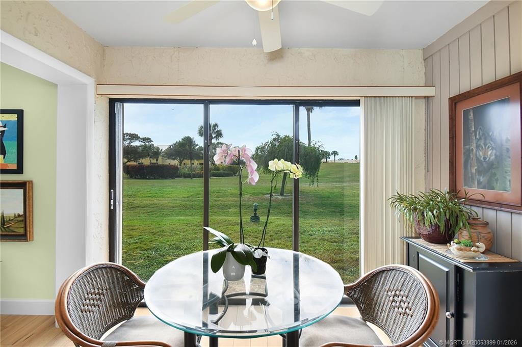 5403 Southeast Miles Grant Road, Unit H111 Stuart, FL 34997 - Photo 19 of 57 a dining room with furniture a chandelier and window