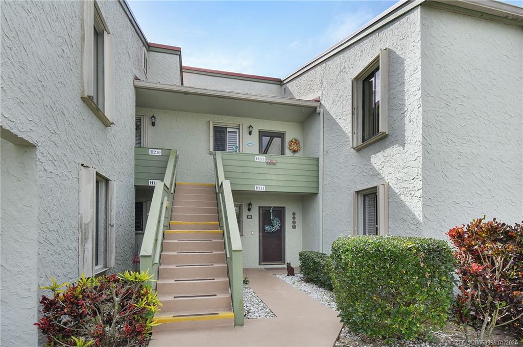 5403 Southeast Miles Grant Road, Unit H111 Stuart, FL 34997 - Photo 2 of 57 a front view of a house with a garden