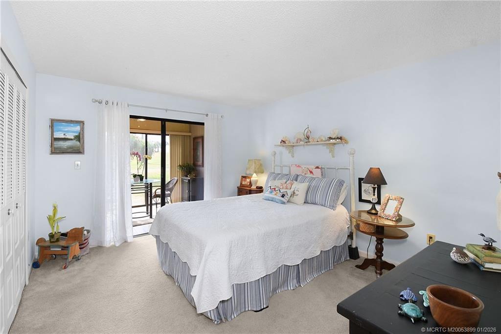 5403 Southeast Miles Grant Road, Unit H111 Stuart, FL 34997 - Photo 22 of 57 a bedroom with a bed and a window
