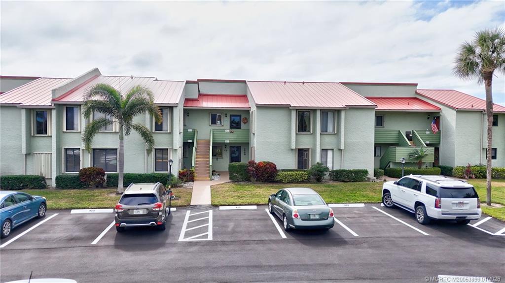 5403 Southeast Miles Grant Road, Unit H111 Stuart, FL 34997 - Photo 29 of 57 a view of a patio with couches and a table and chairs with garden view