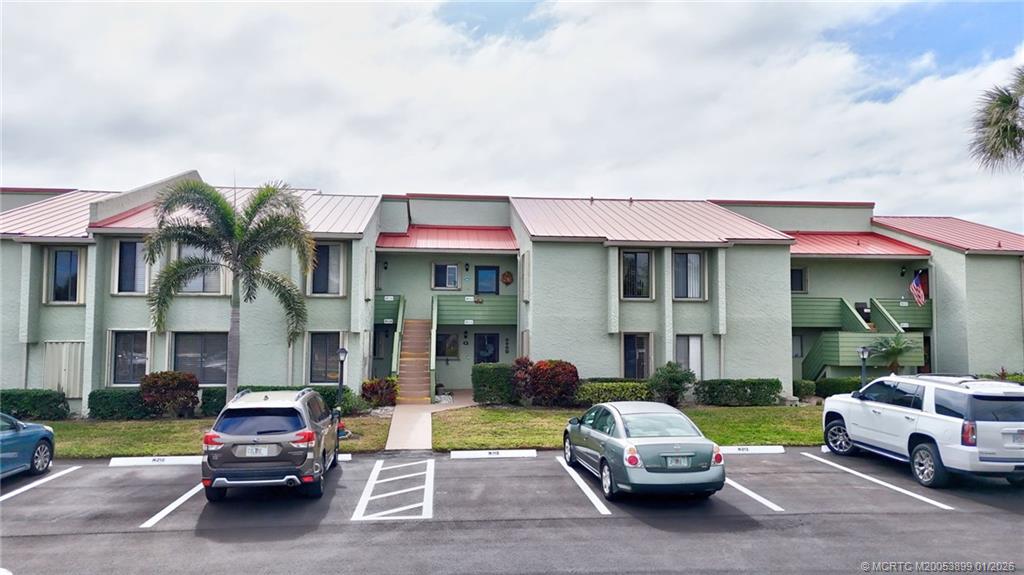 5403 Southeast Miles Grant Road, Unit H111 Stuart, FL 34997 - Photo 36 of 57 a car parked in front of a house