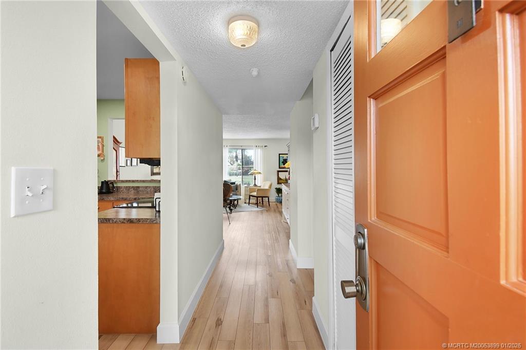 5403 Southeast Miles Grant Road, Unit H111 Stuart, FL 34997 - Photo 4 of 57 a view of a living room with a wooden floor