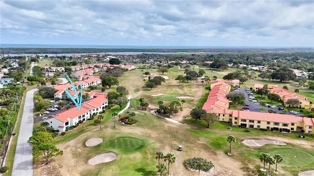 5403 Southeast Miles Grant Road, Unit H111 Stuart, FL 34997 - Photo 42 of 57 an aerial view of residential houses with outdoor space and trees