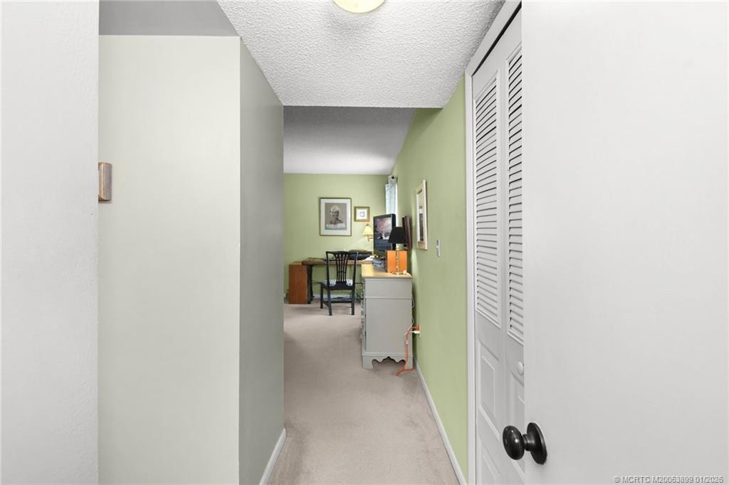 5403 Southeast Miles Grant Road, Unit H111 Stuart, FL 34997 - Photo 5 of 57 a view of a hallway with a livingroom and a chair