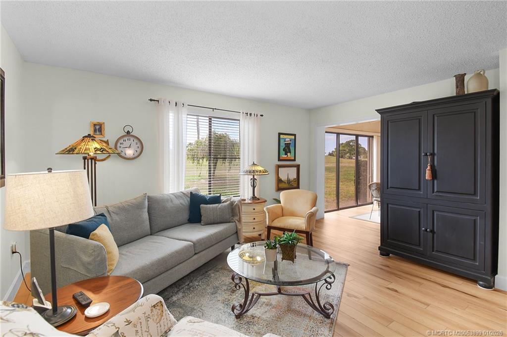 5403 Southeast Miles Grant Road, Unit H111 Stuart, FL 34997 - Photo 6 of 57 a living room with furniture and wooden floor