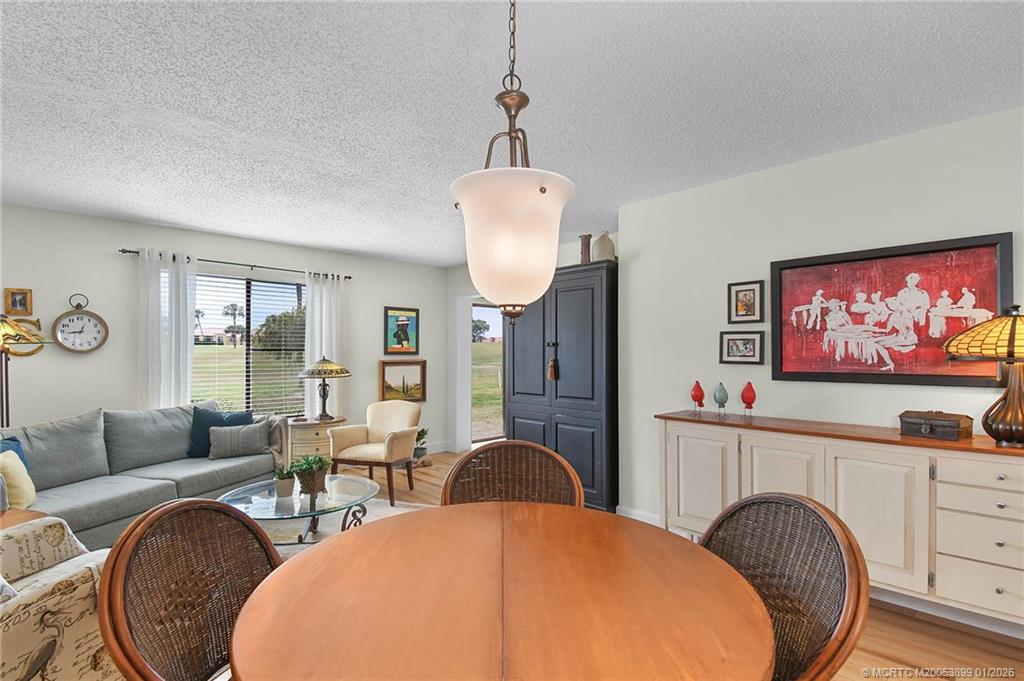 5403 Southeast Miles Grant Road, Unit H111 Stuart, FL 34997 - Photo 8 of 57 a living room with furniture a table and window