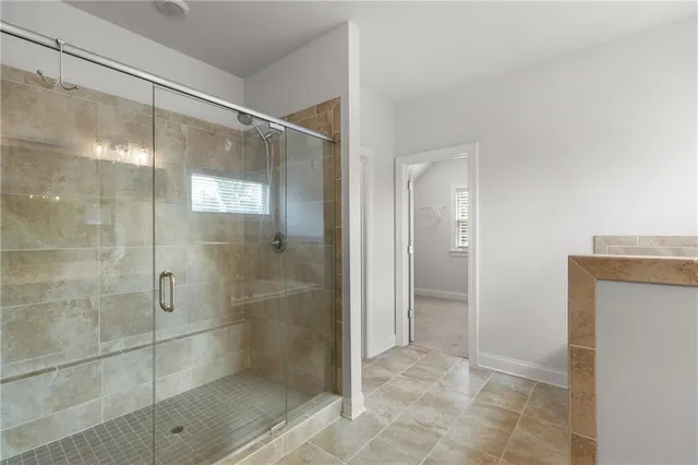 a bathroom with a glass shower door