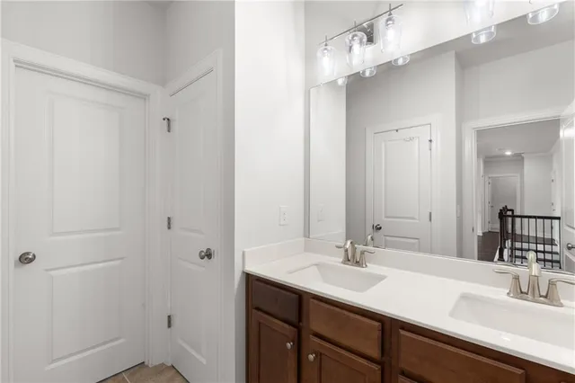 a bathroom with a sink double vanity and a mirror