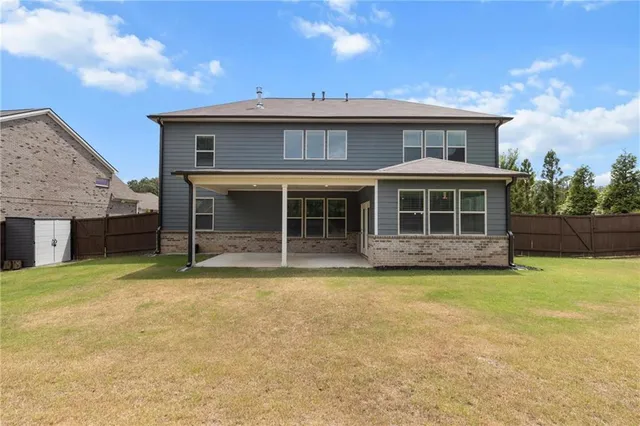 a view of a house with a yard and balcony
