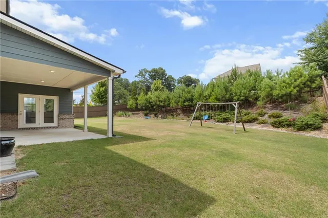 a view of a house with a backyard and a garden