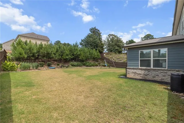 a view of a backyard with a garden and fire pit
