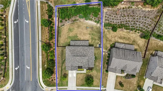 an aerial view of residential houses with outdoor space