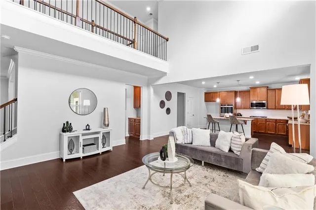 a living room with furniture and a wooden floor