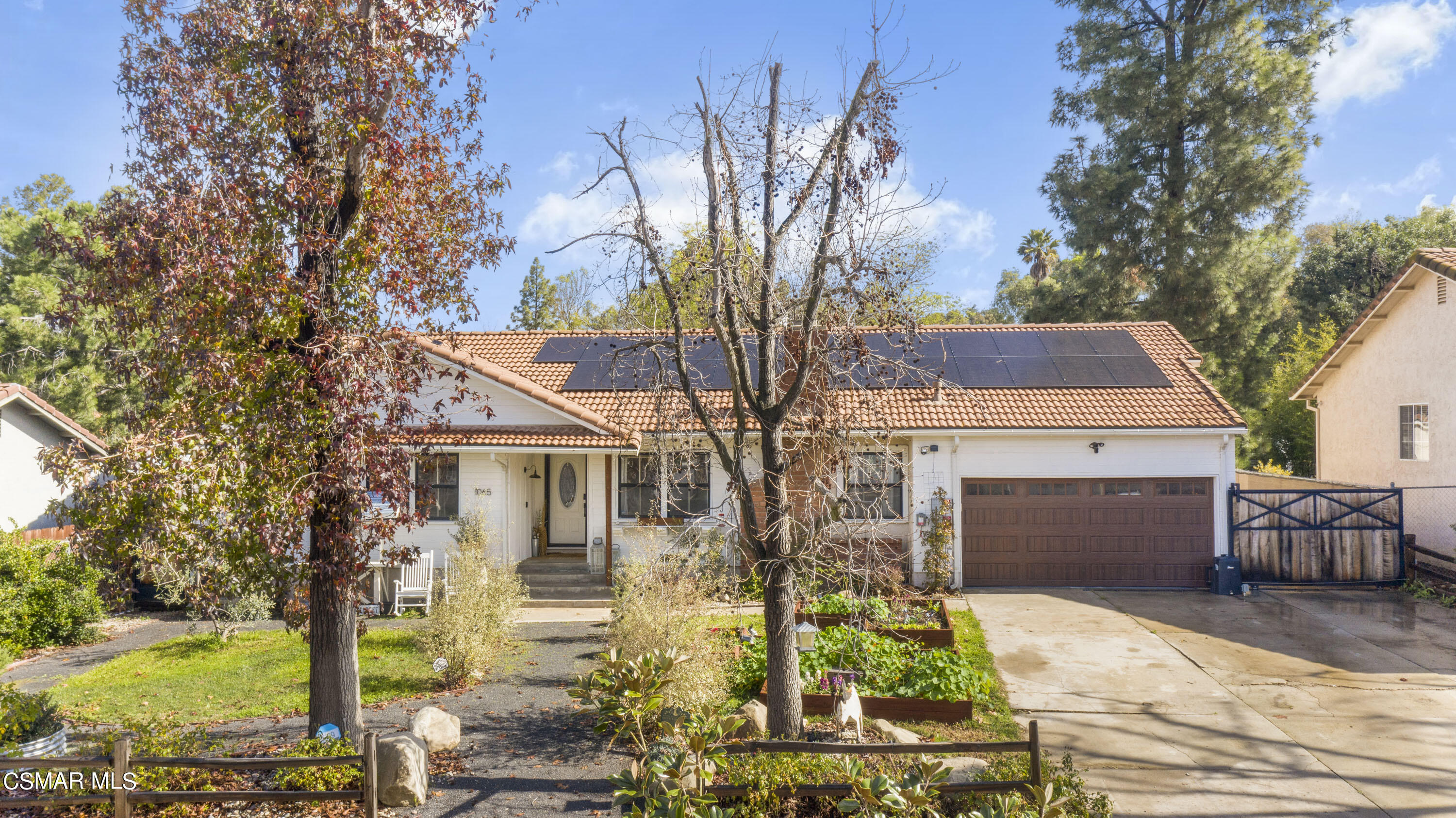 1065 Rambling Road Simi Valley, CA 93065 - Photo 1 of 54 a front view of a house with garden